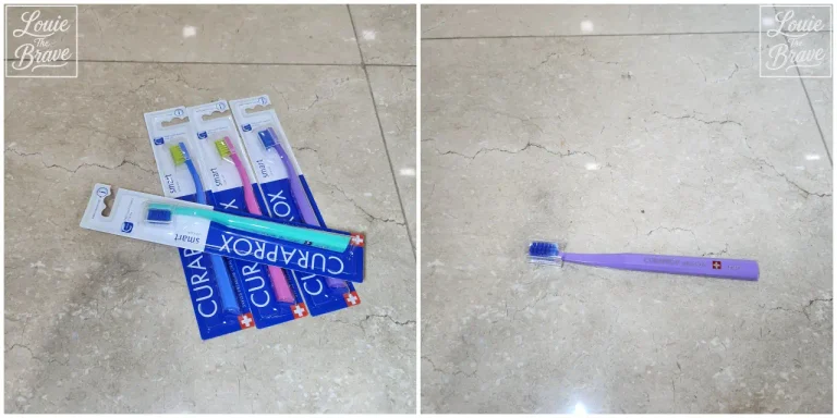 Curaprox CS Smart toothbrush for dogs shown in several packages beside one purple brush on a marble floor (대리석 바닥 위에 버박 치약과 같이 쓰는 여러 개의 포장된 큐라프록스 CS Smart 칫솔과 보라색 칫솔 한 개가 놓인 모습)